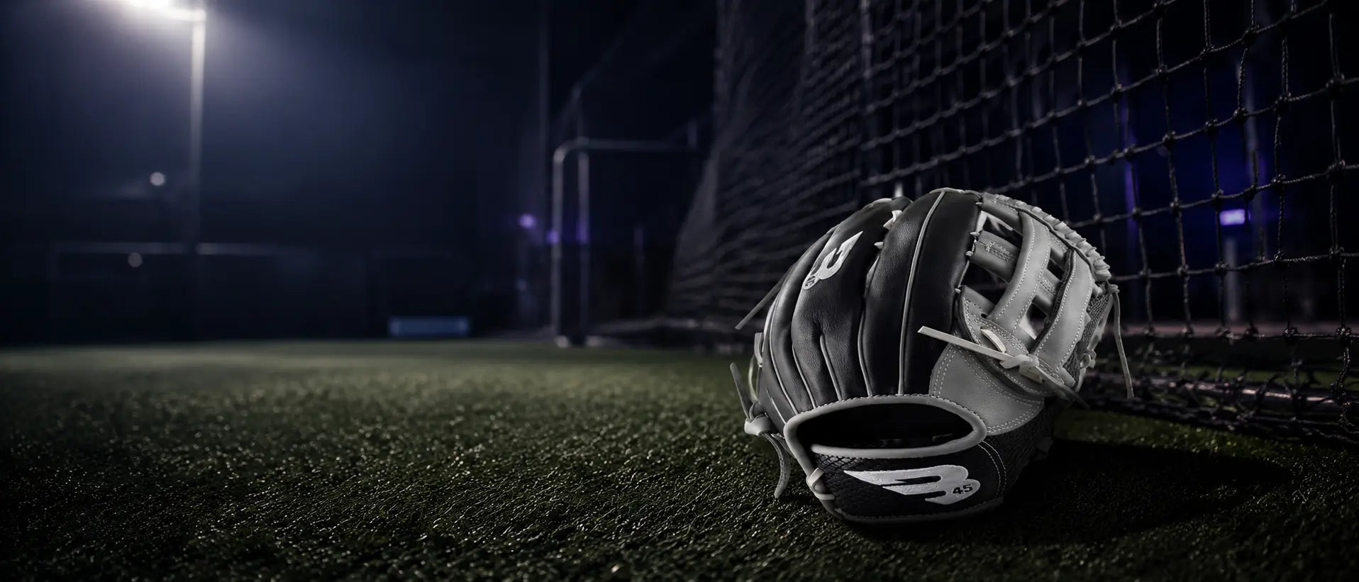 Baseball glove near a batting cage net
